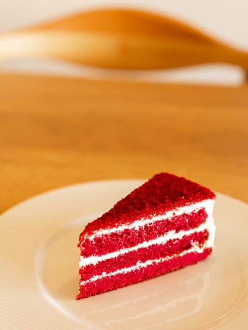 Free Close-up of a delicious red velvet cake slice on a white plate, perfect for dessert inspiration. Stock Photo
