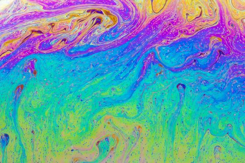 Free Colorful psychedelic fluid pattern with vibrant swirls and multicolored texture. Stock Photo
