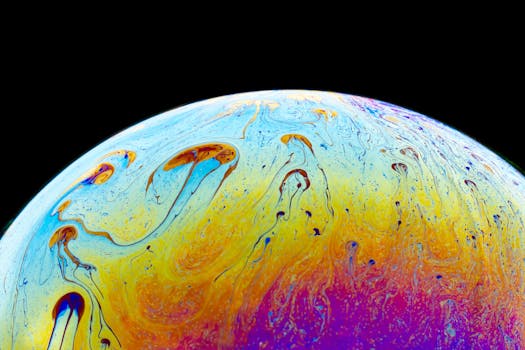 Close-up of a colorful soap bubble displaying vibrant iridescent patterns against a black background.