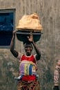 Woman Balancing Basket in Vibrant Traditional Wear