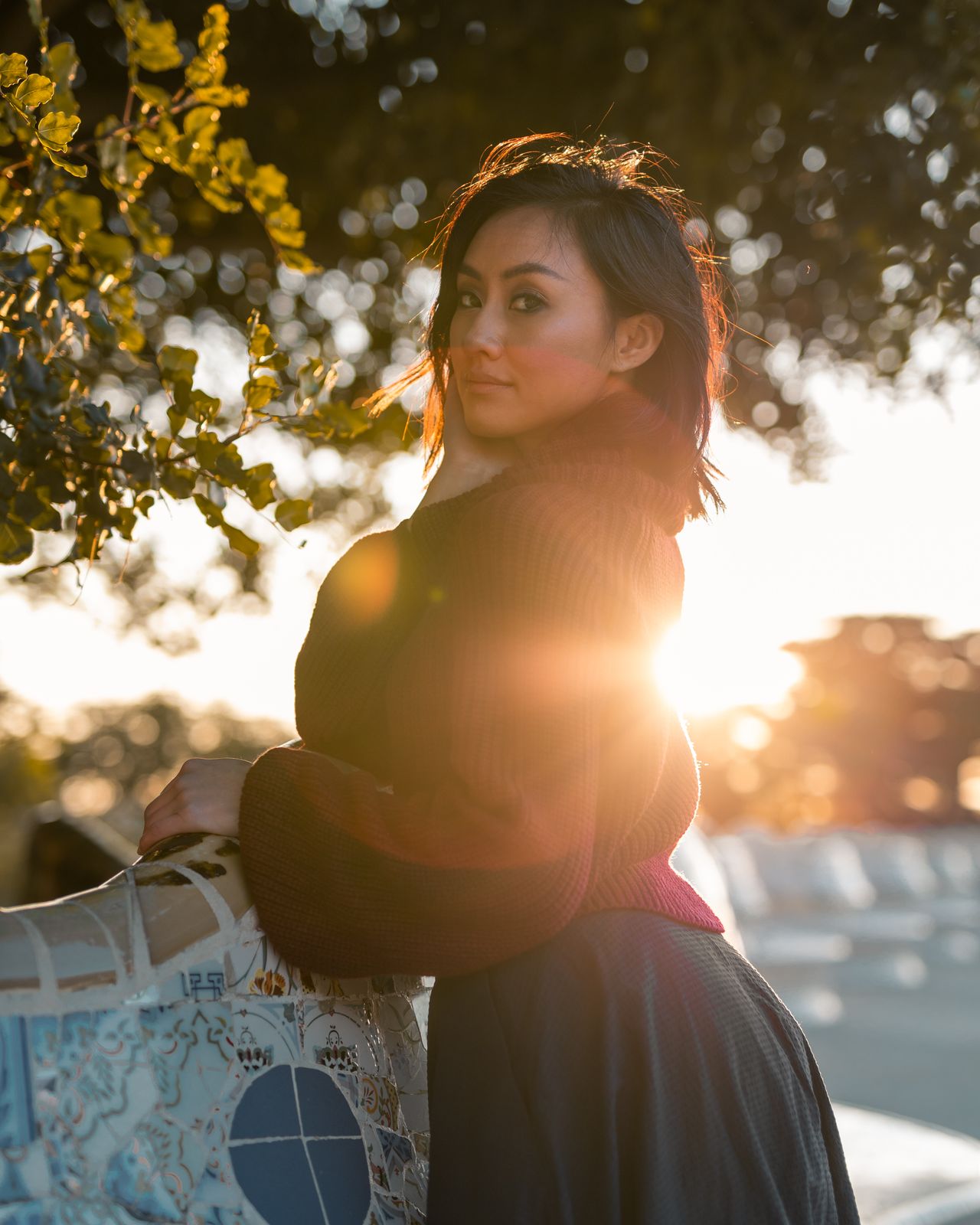 Woman in a red turtleneck knit sweater at sunset