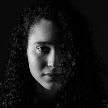 Expressive black and white portrait of a woman with curly hair