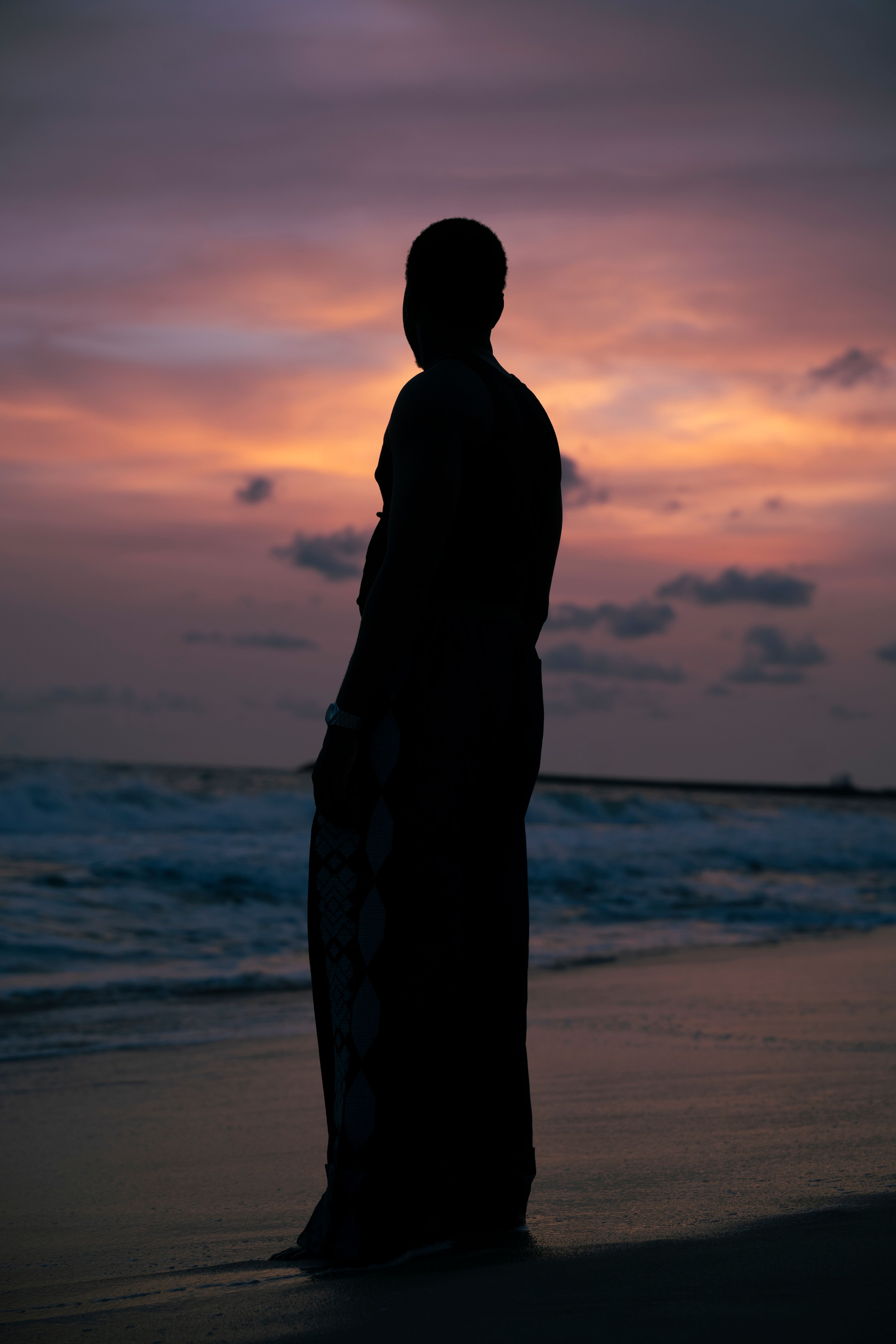Silhouette of Person by Ocean at Sunset · Free Stock Photo