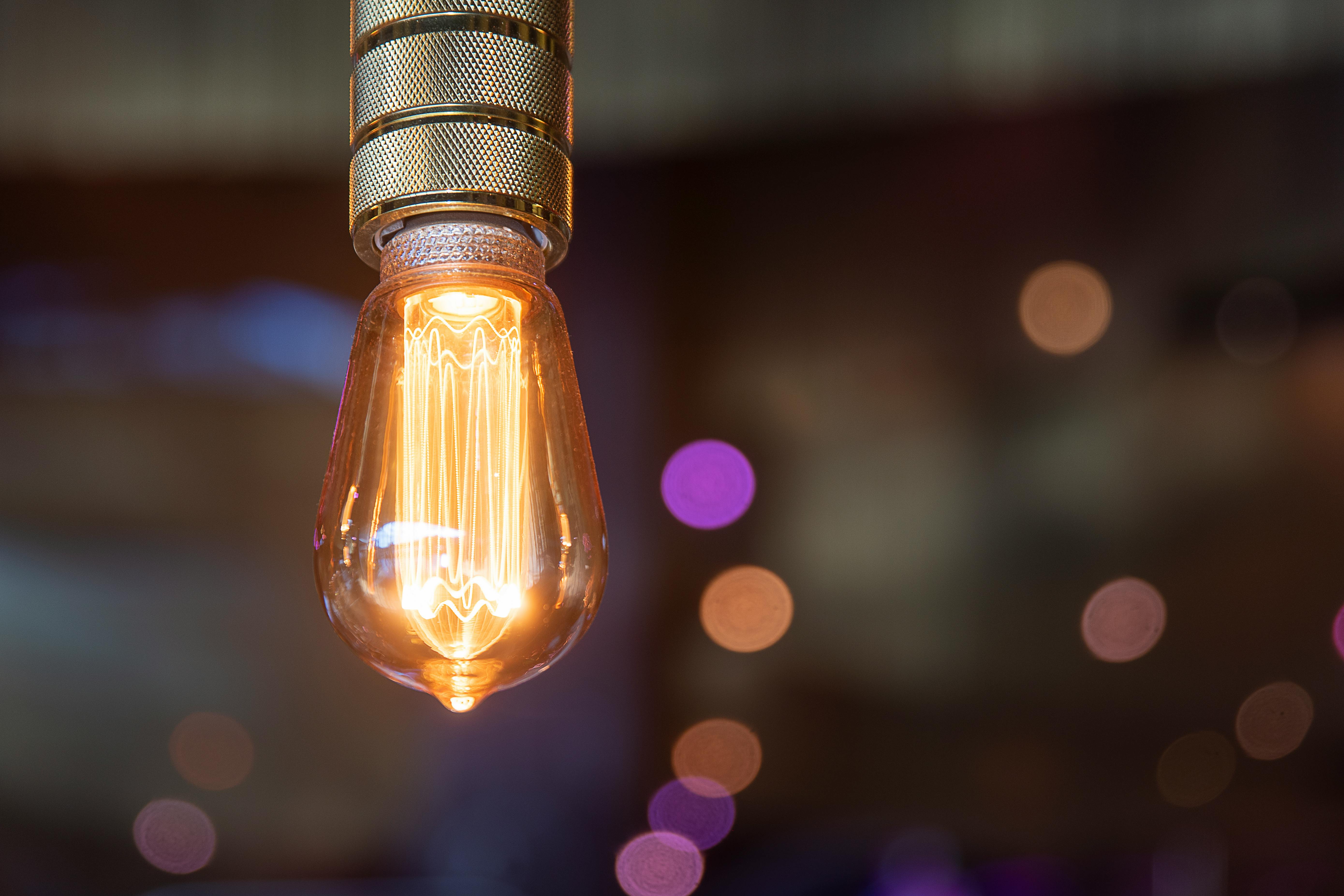 Elegant vintage Edison bulb glowing against a bokeh-effect background. Perfect for ambient and decor themes.