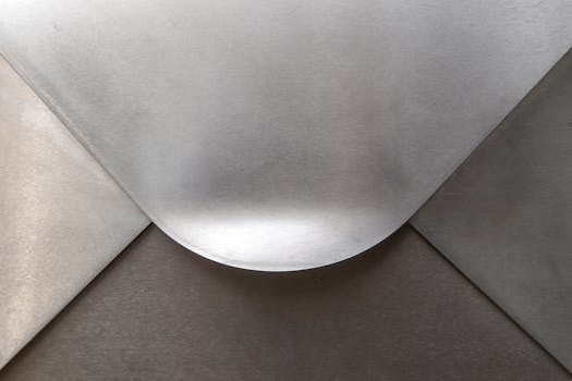 Close-up view of a silver metallic envelope with elegant curves and textures.