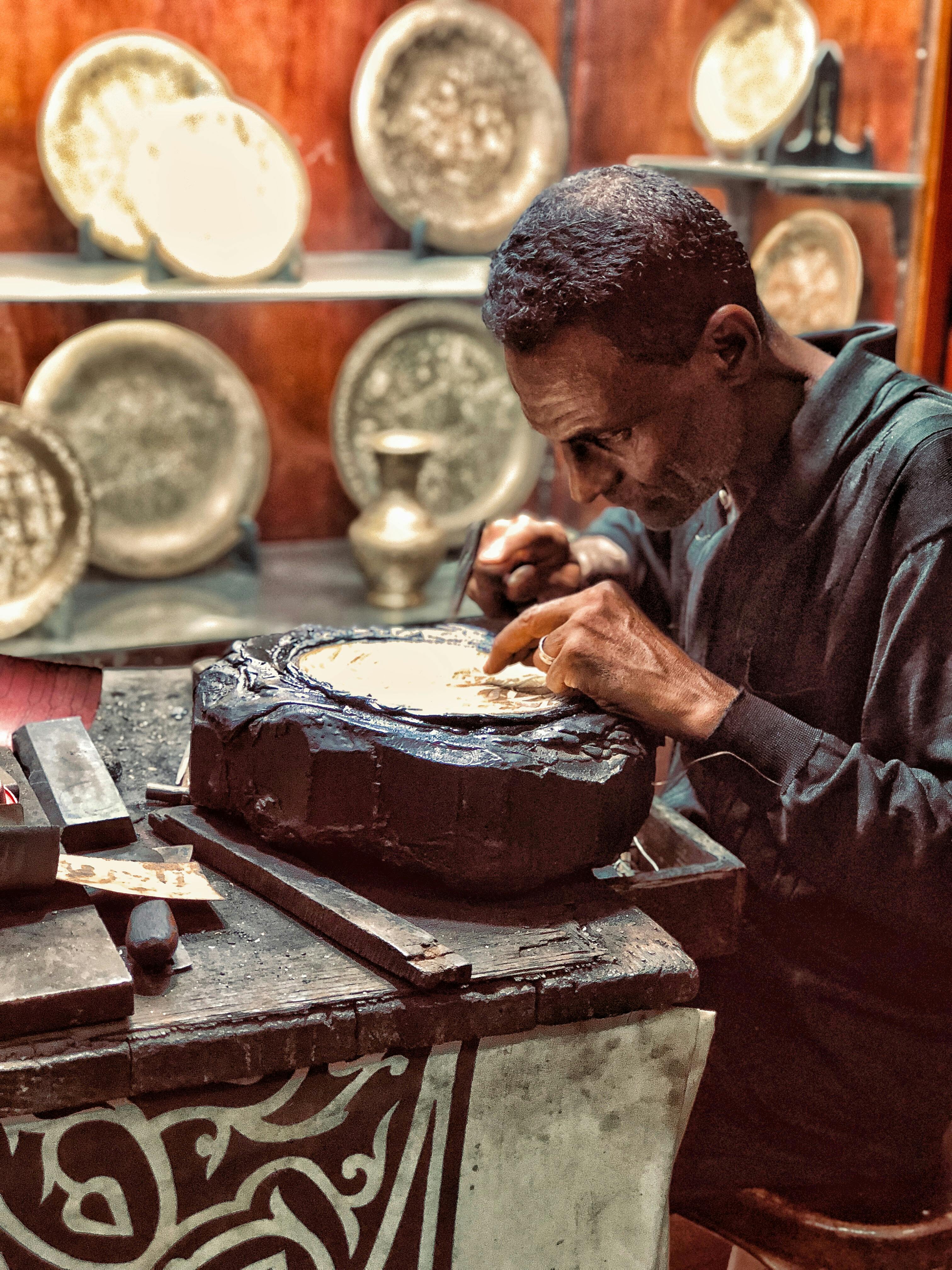 man making decorative plates