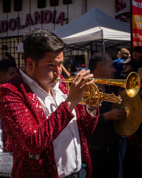 Free Trumpet player in a vibrant costume at a lively Mexican carnival in Hidalgo. Stock Photo