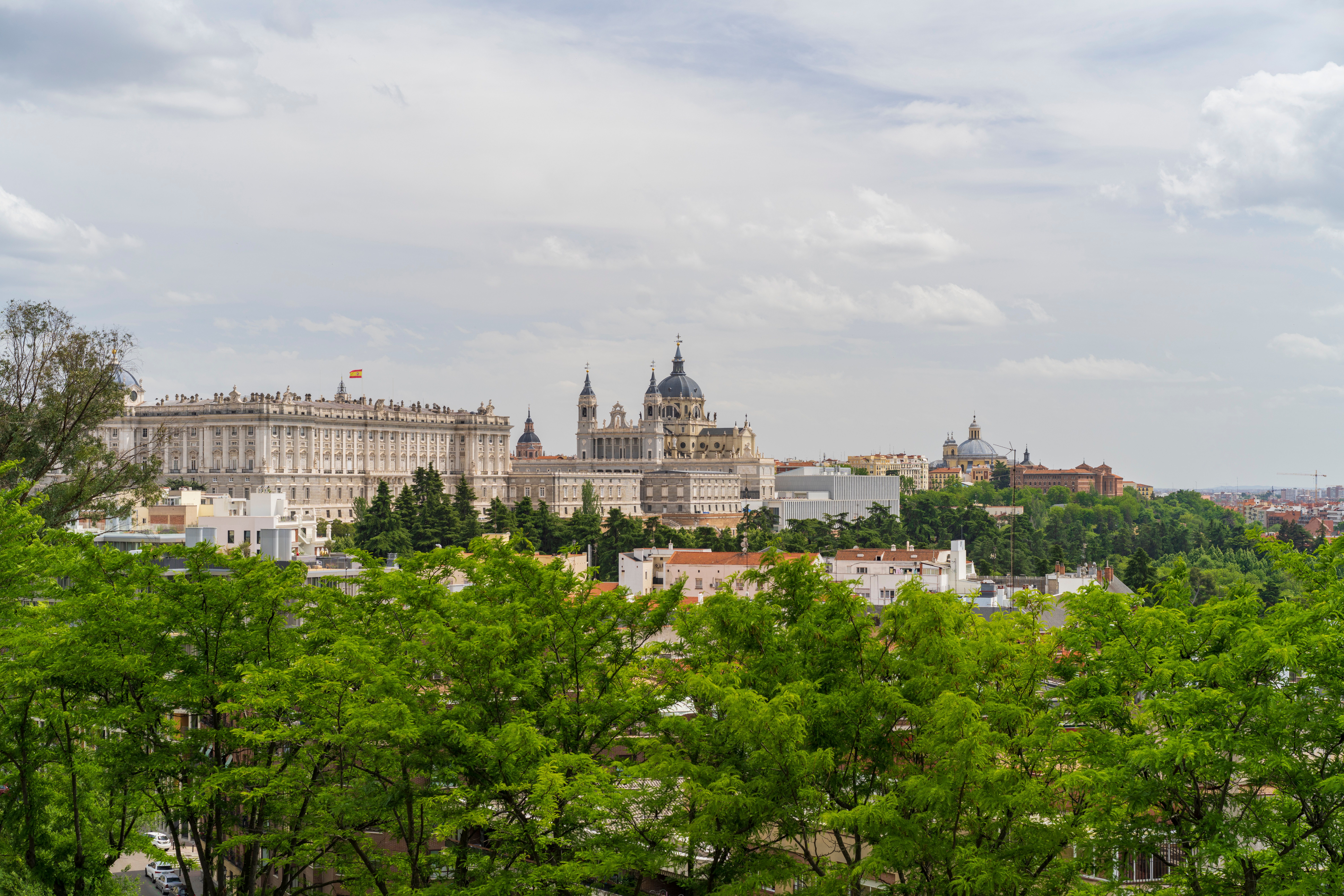 Royal Palace of Madrid and surrounding skyline greenery.