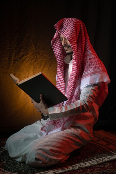 Man Praying with Rosary Beads in Traditional Attire · Free Stock Photo
