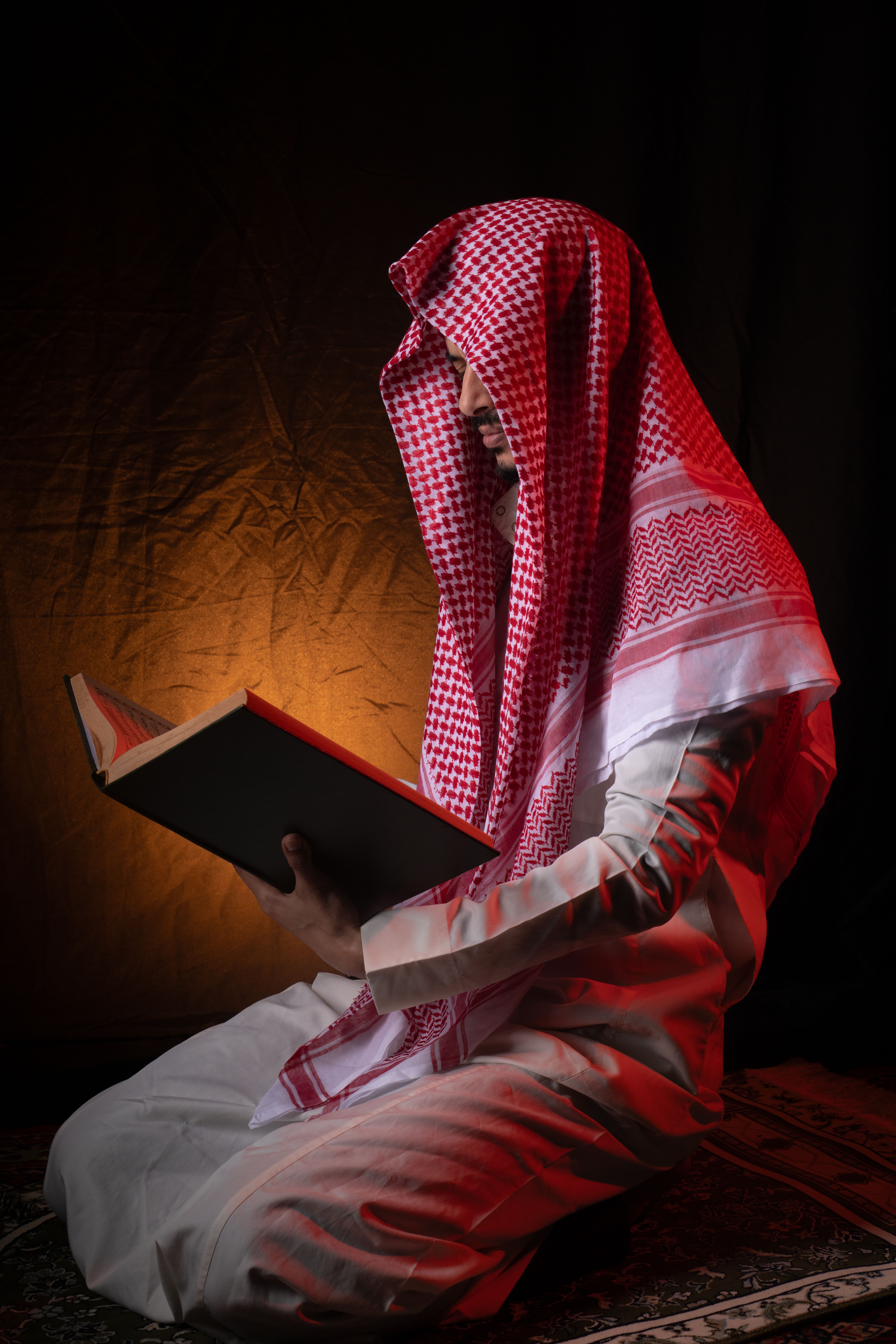 Man Praying with Rosary Beads in Traditional Attire · Free Stock Photo