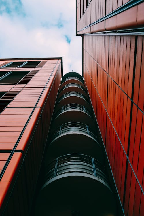 Low Angle Shot of Black and Red Building Under Blue Sky