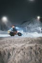 Snowplow Clearing Streets on a Winter Night