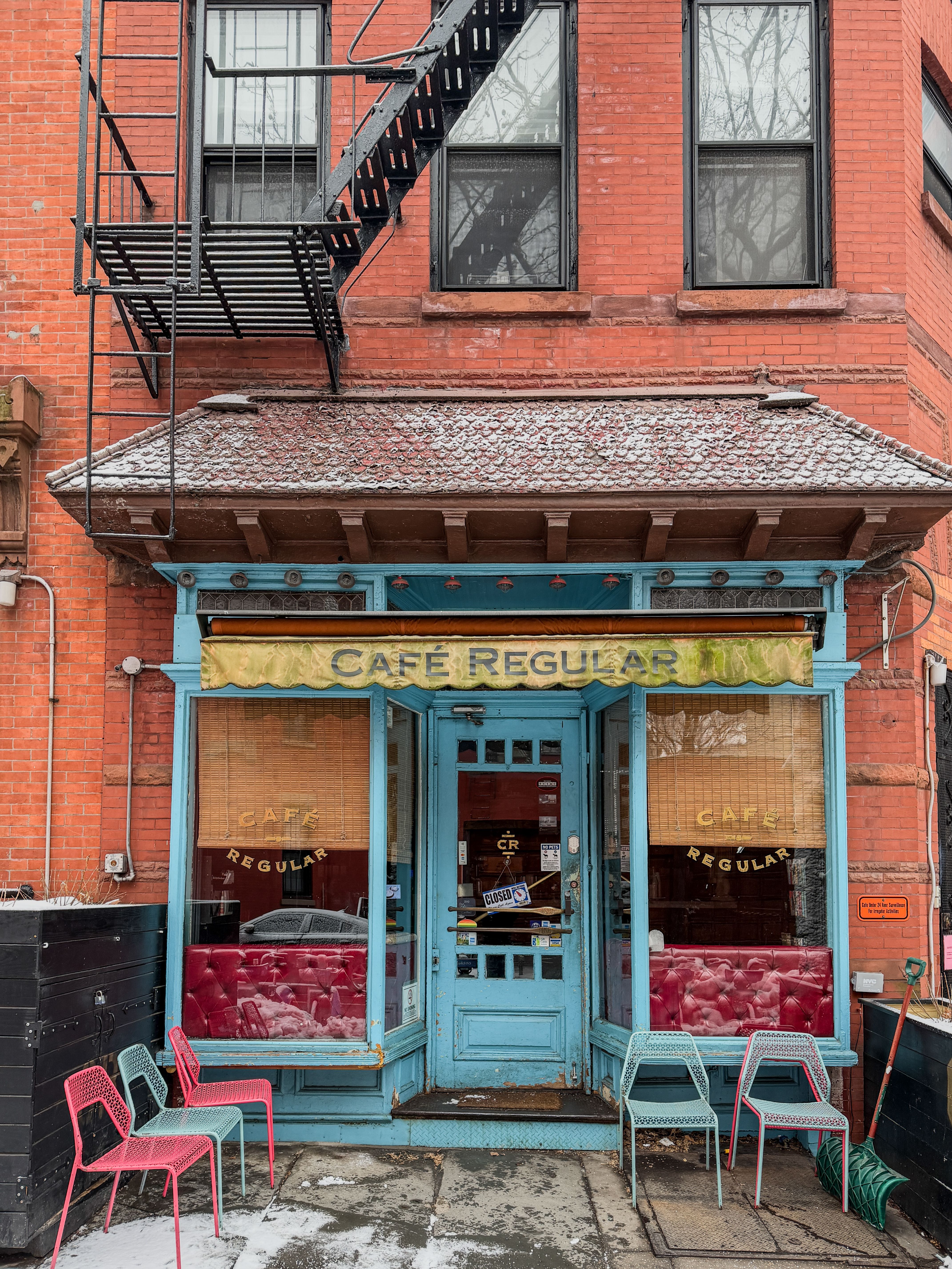 Vintage brick facade of a quaint Brooklyn cafe in New York, ideal for street photography.