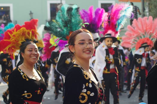 Colorful costumes and joyful participants at a carnival parade in Tlaxcala, Mexico.