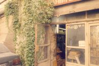 Explore a vintage shop in Old Damascus with ivy-covered facade and rustic charm.