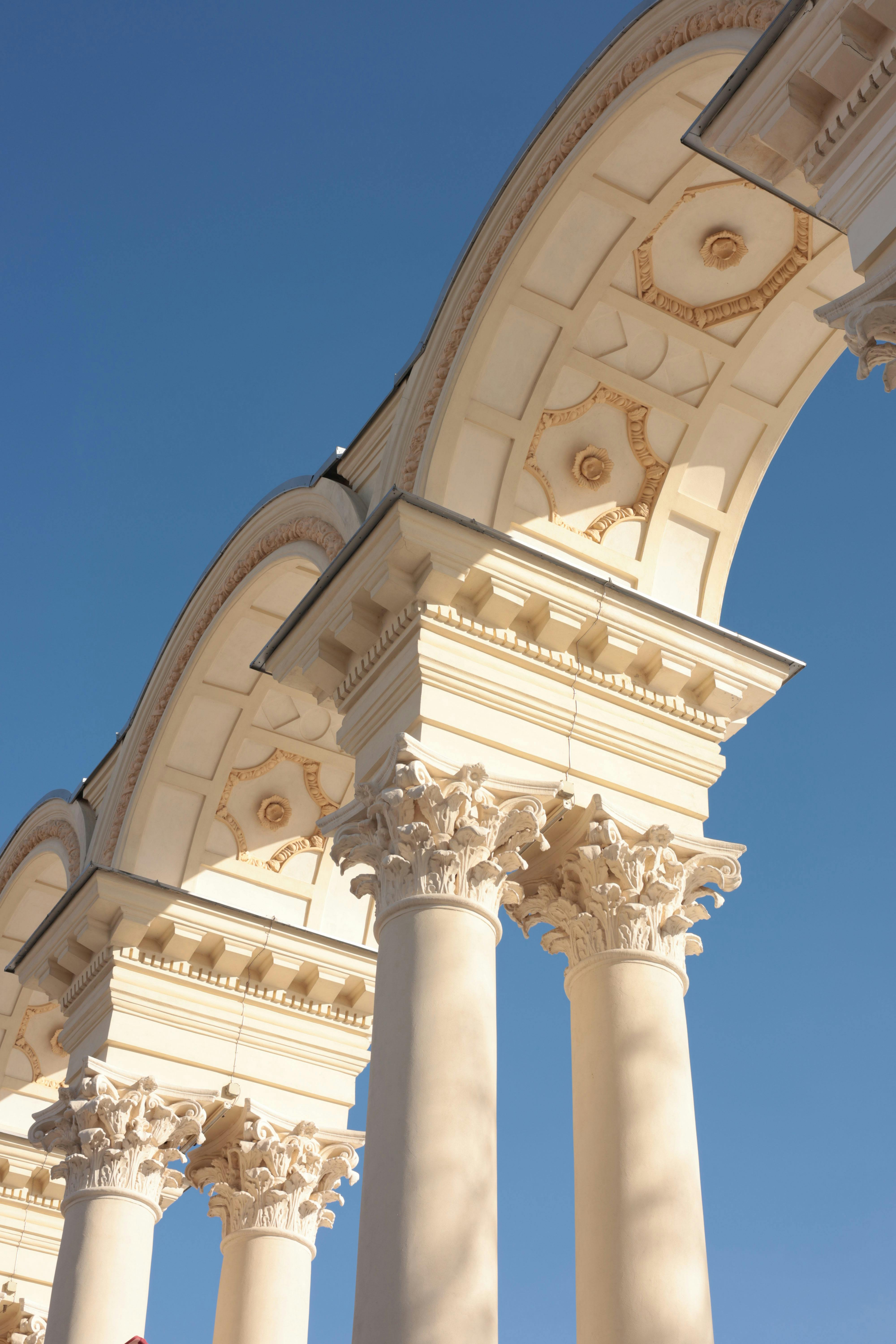 Gratis Impresionante vista de columnas neoclásicas con capiteles ornamentados contra un cielo azul claro. Foto de stock