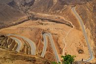Captivating view of a winding road through Dhofar's arid mountains, Oman.