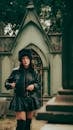 Stylish Woman in Gothic Cemetery Setting