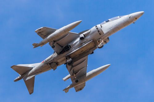 Free A modern military fighter jet flying against a clear blue sky, showcasing aviation technology. Stock Photo