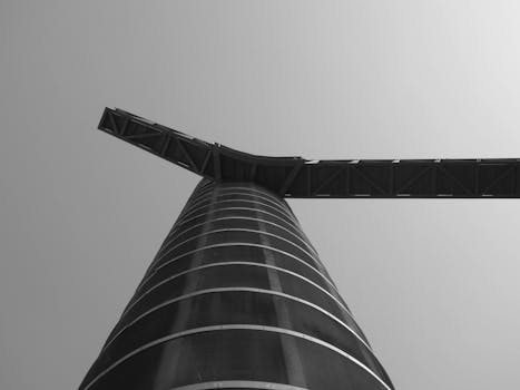 A striking black and white view of a modern tower structure in Cartagena, Spain.
