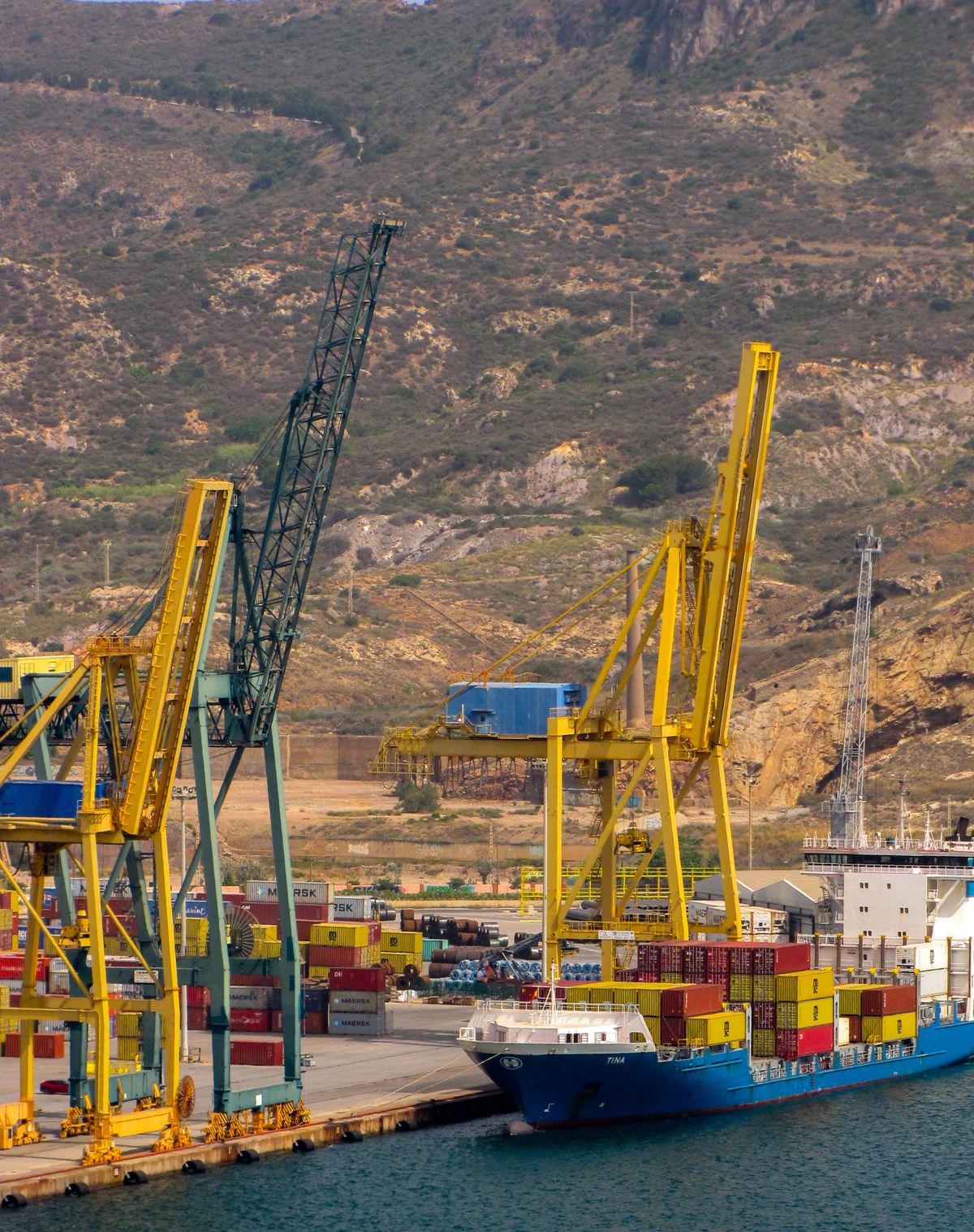 Container ship docked at a port with cranes