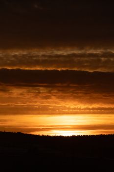 Breathtaking sunset in Norway with silhouetted landscape and vibrant sky.
