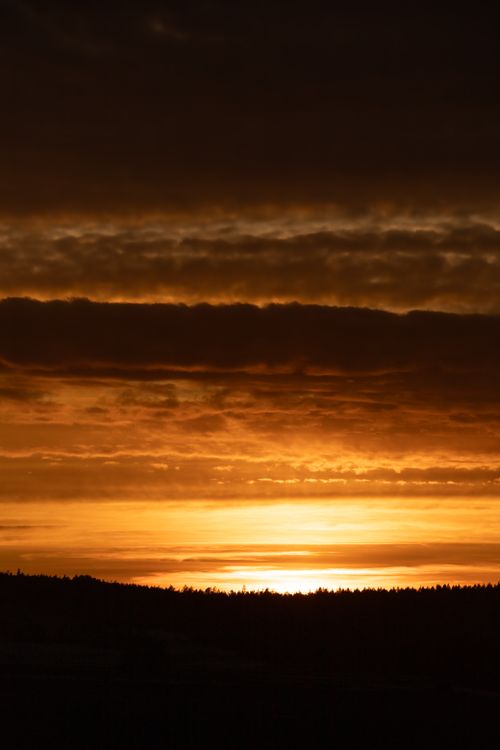 Free Breathtaking sunset in Norway with silhouetted landscape and vibrant sky. Stock Photo