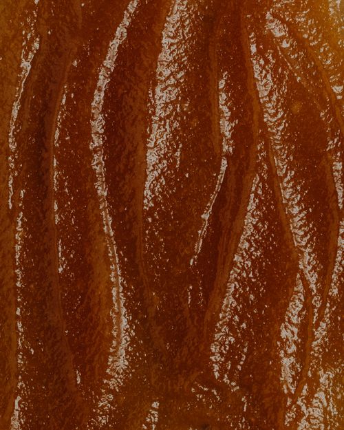Free Detailed close-up of a natural wood texture highlighting rich brown tones and intricate patterns. Stock Photo