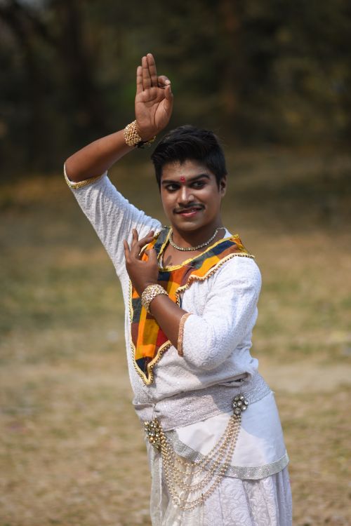 Free South Asian man performing classical Indian dance outdoors, showcasing cultural attire. Stock Photo