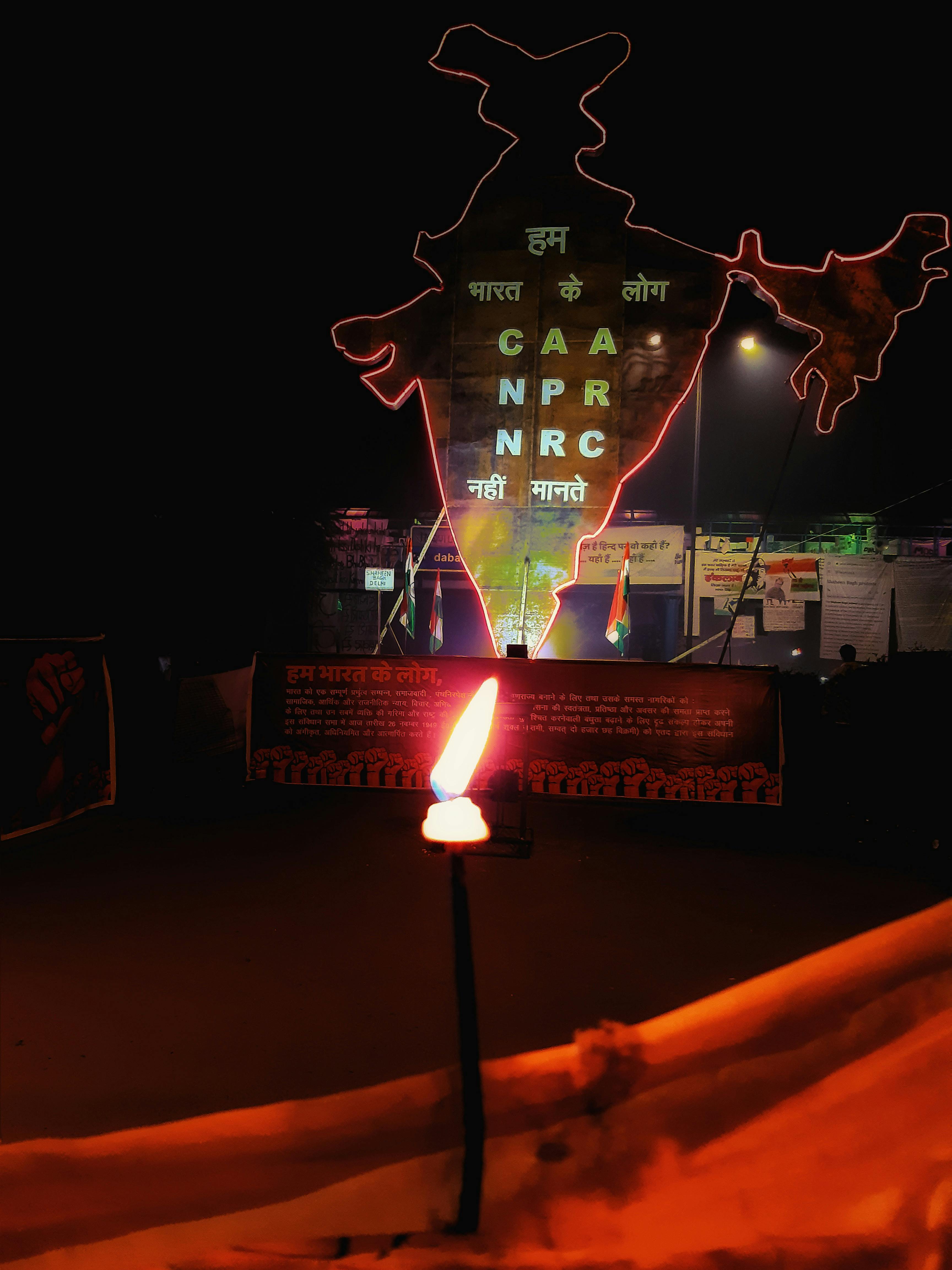 A dog drinking water from a portable bowl on a sunny day outdoors