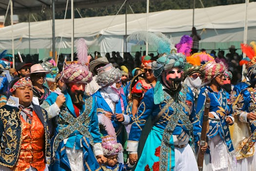 A lively street parade with performers in vibrant traditional costumes and masks at a cultural festival.
