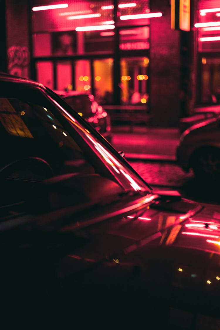 Red Car On The Road During Night Time