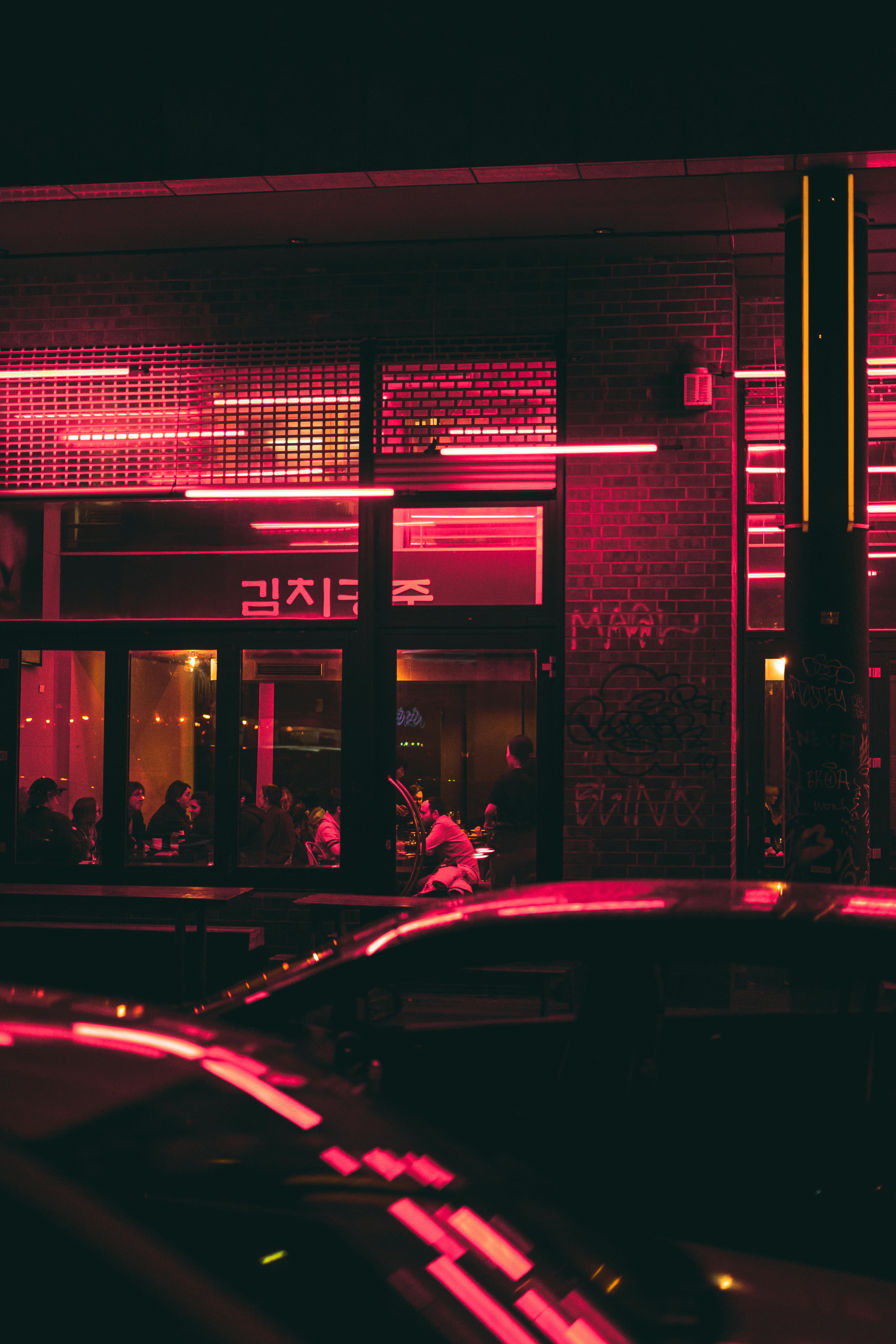 red light reflection on cars and building