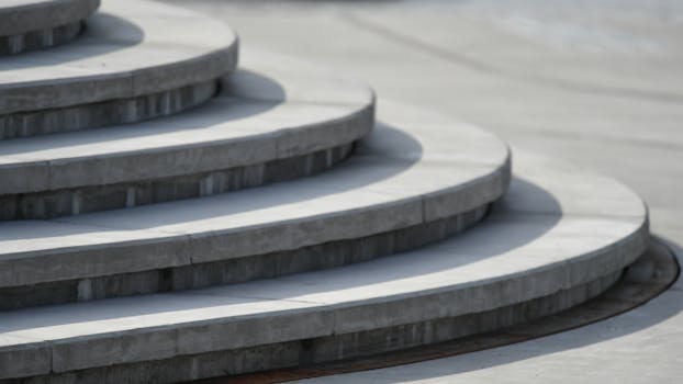 A close-up view of smooth, curved concrete steps with shadows.