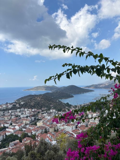 Free A picturesque view of Kas, Turkey, with vibrant bougainvillea and the Aegean Sea in the background. Stock Photo