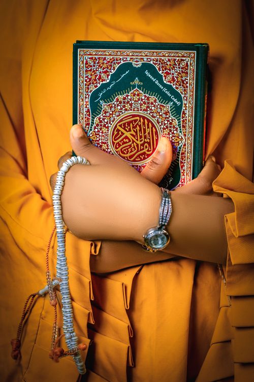Free Close-up of hands holding a sacred religious book, emphasizing cultural and spiritual themes. Stock Photo