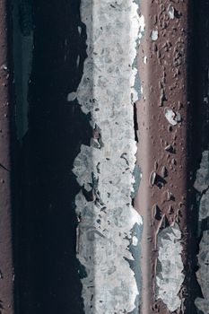 Detailed texture of a rusty and corroded metal surface, showcasing peeling paint and weathering.