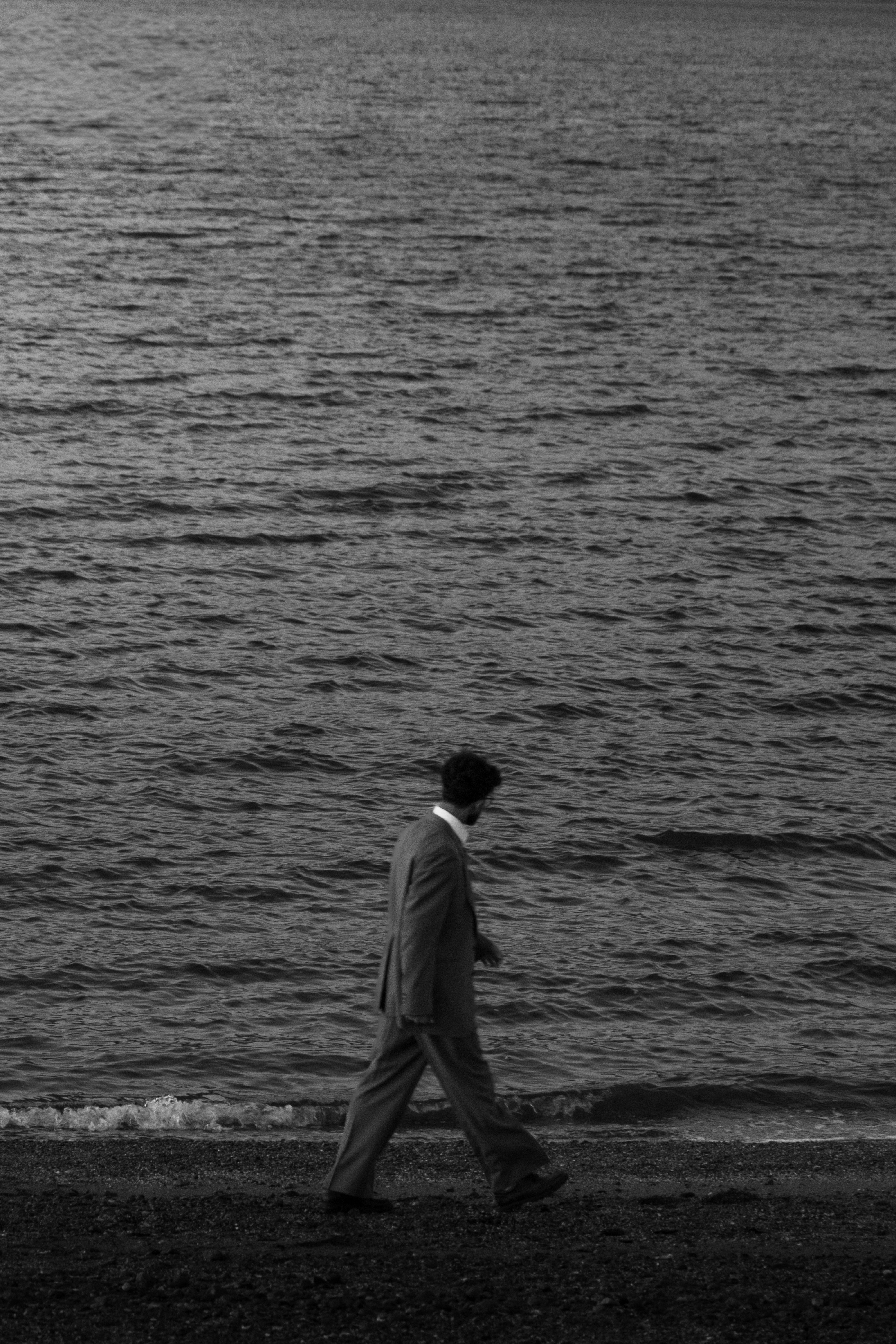 Black and White Man Walking by the Sea · Free Stock Photo