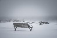 Lonely Park Bench in Snowy Winter Storm