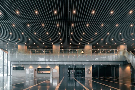 A spacious and luxurious office lobby in Varanasi featuring modern architecture and elegant interior design.