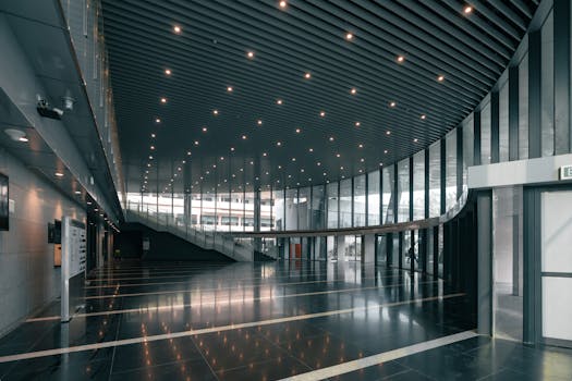 Spacious modern corporate hall with glass walls and sleek design, Varanasi.