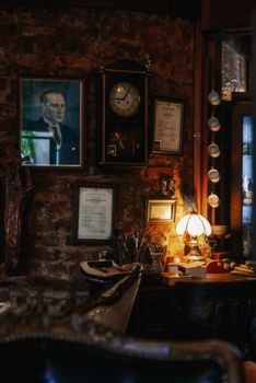 Vintage study room with warm lighting, classic decor, and vintage clock.