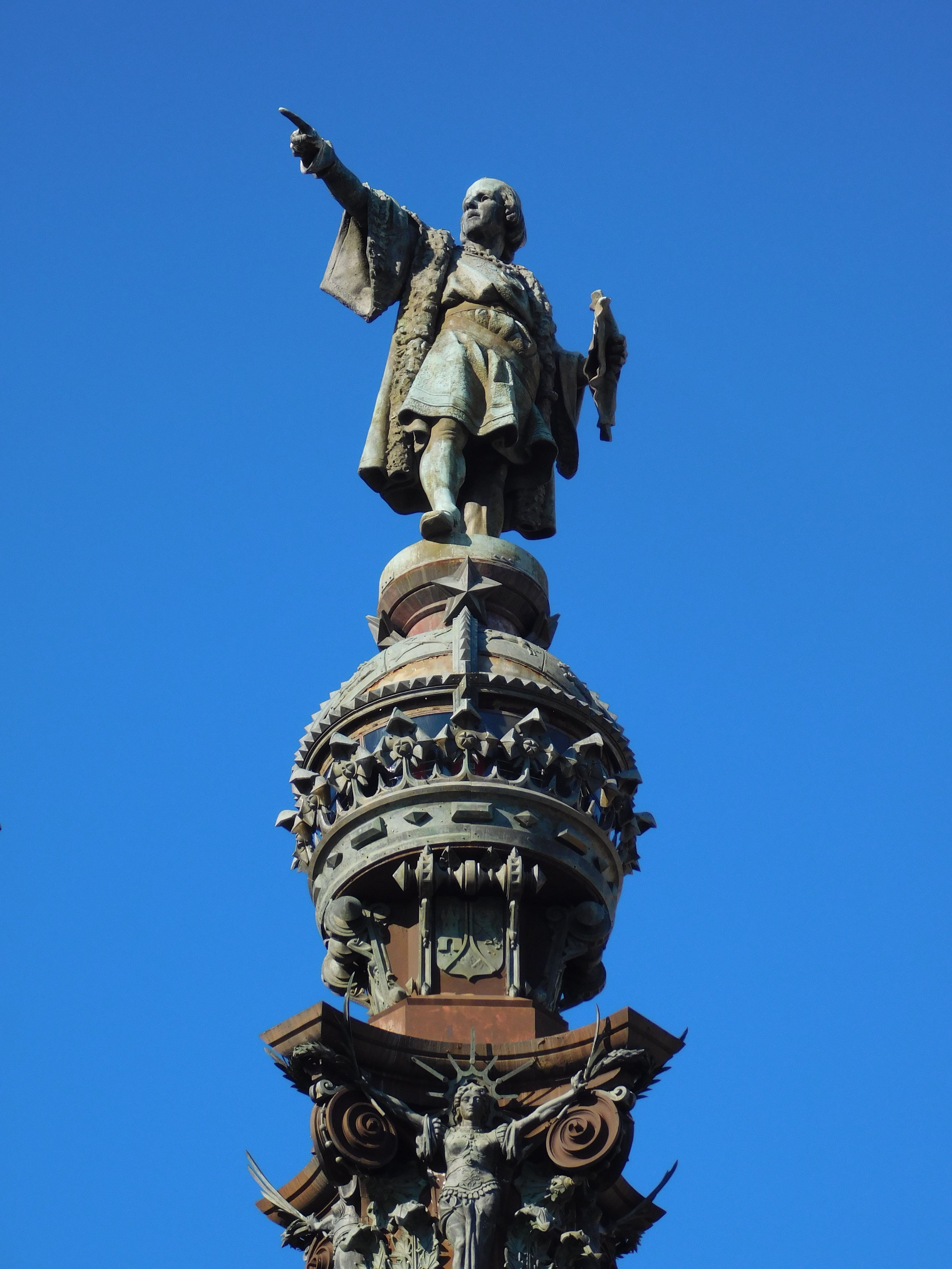 Close-up of the iconic Columbus Monument in Barcelona under a clear blue sky.
