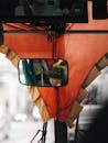 Reflection of Bus Passenger in Rearview Mirror