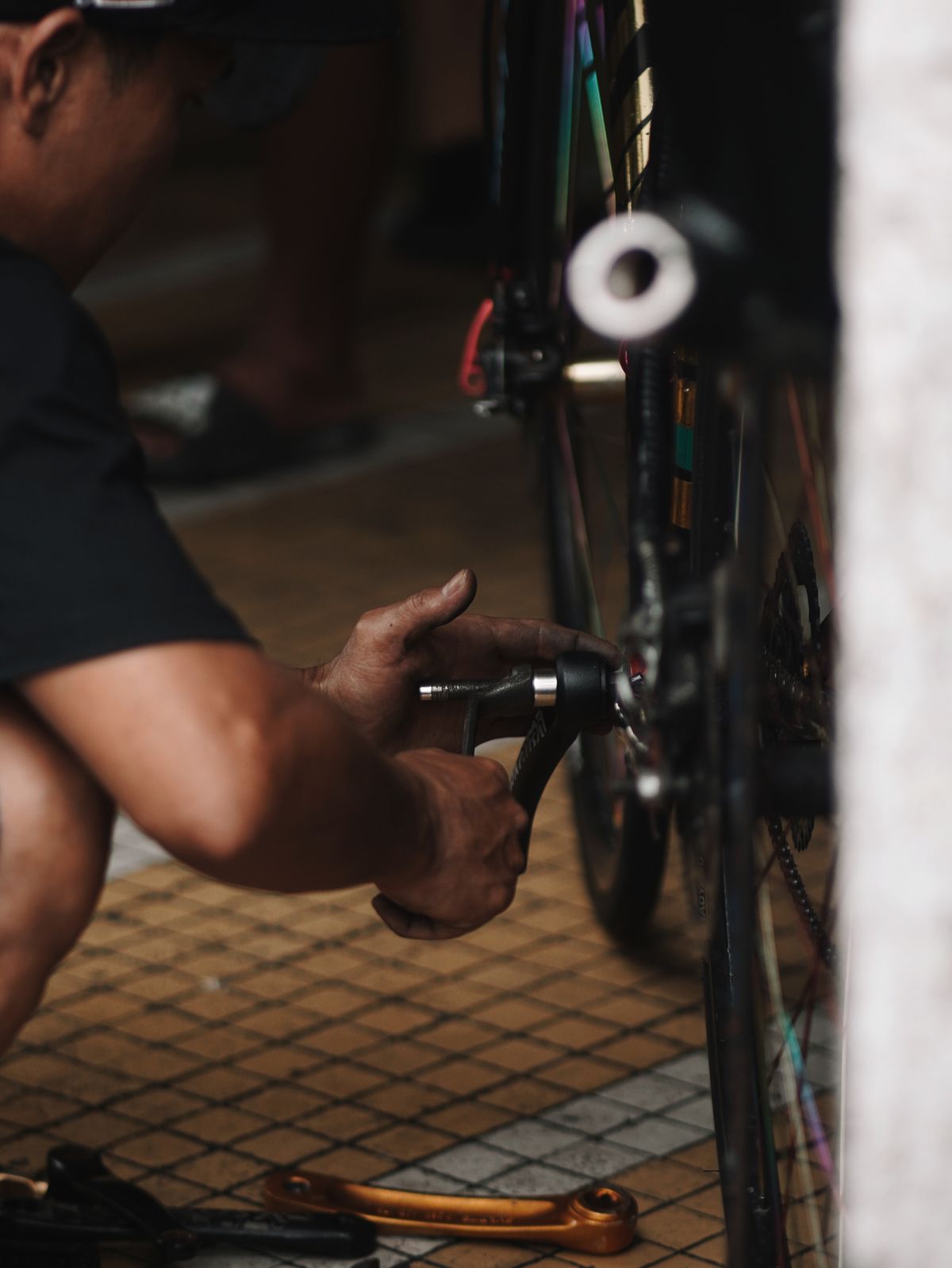 Bicycle wheel being carefully inspected and maintained in a workshop