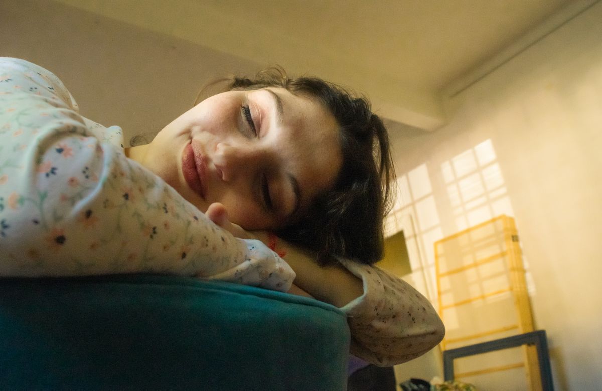 Woman resting indoors in soft natural light