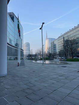 A view of Milan's modern architectural landscape, featuring iconic skyscrapers at daybreak.