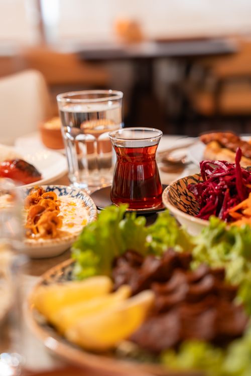 Free A vibrant display of Turkish tea and meze dishes with fresh greens, shot in a local Ünye eatery. Stock Photo