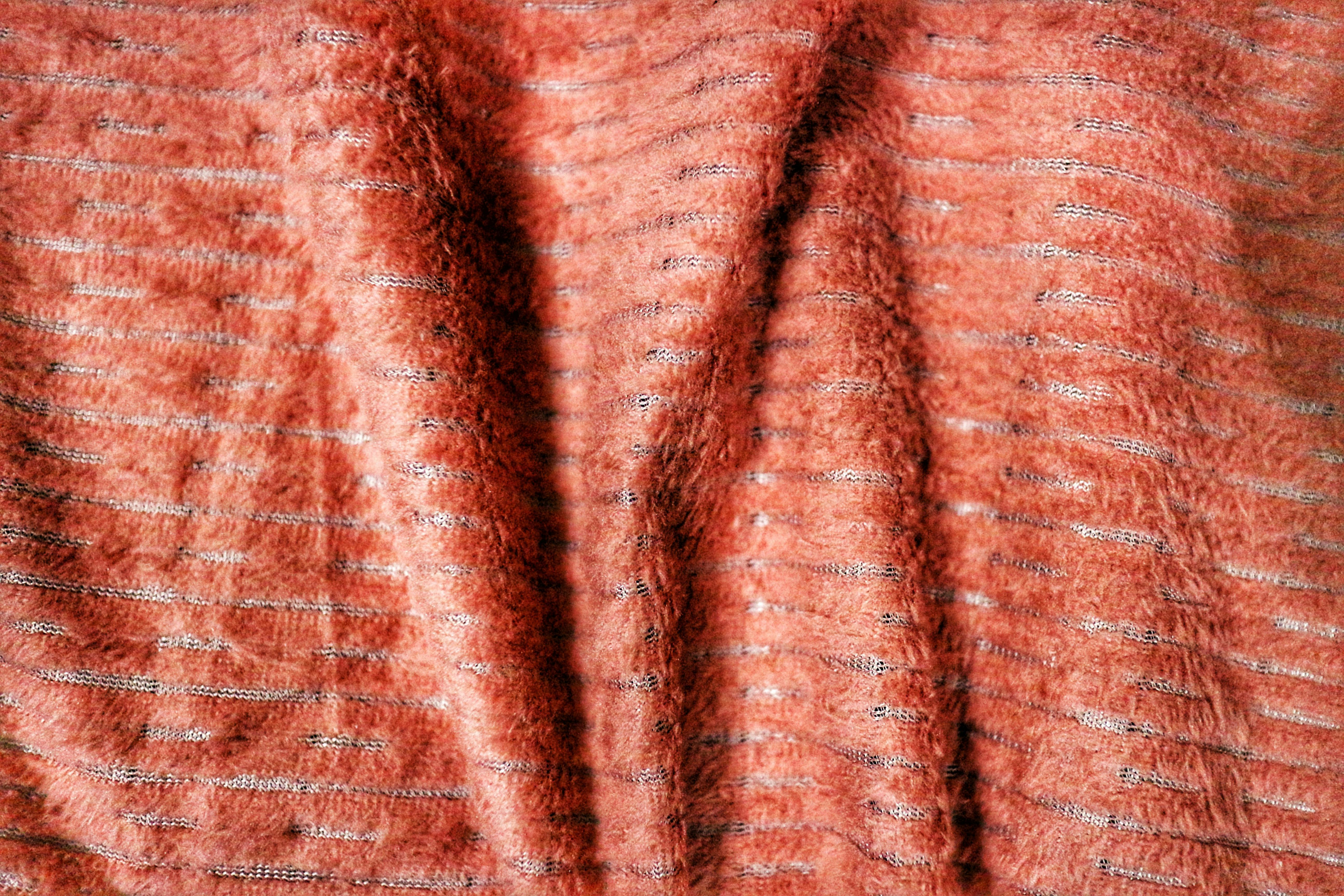 Gratis Nærbilde av varmt oransje stoff med teksturerte striper, ideelt for mønsterbakgrunner. Arkivbilde