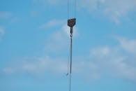 Industrial Crane Hook Against Clear Blue Sky